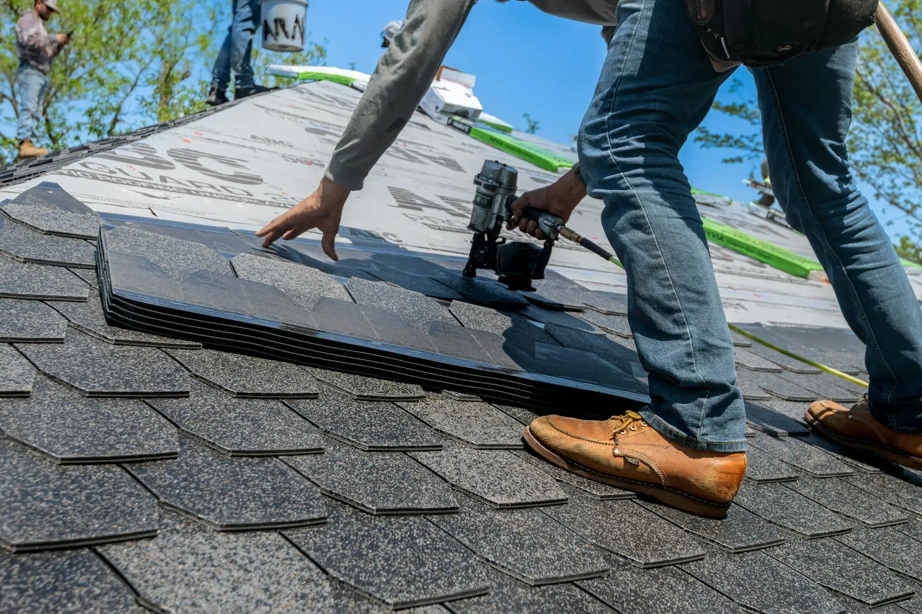 Professional roofing crew installing architectural asphalt shingles on a commercial property in Centerville, Ohio.