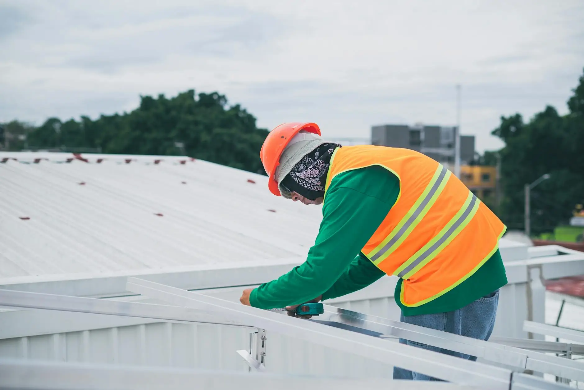 A professional roofing crew installing high-quality GAF shingles on a home in Clearfield, Utah, wearing proper safety harnesses.